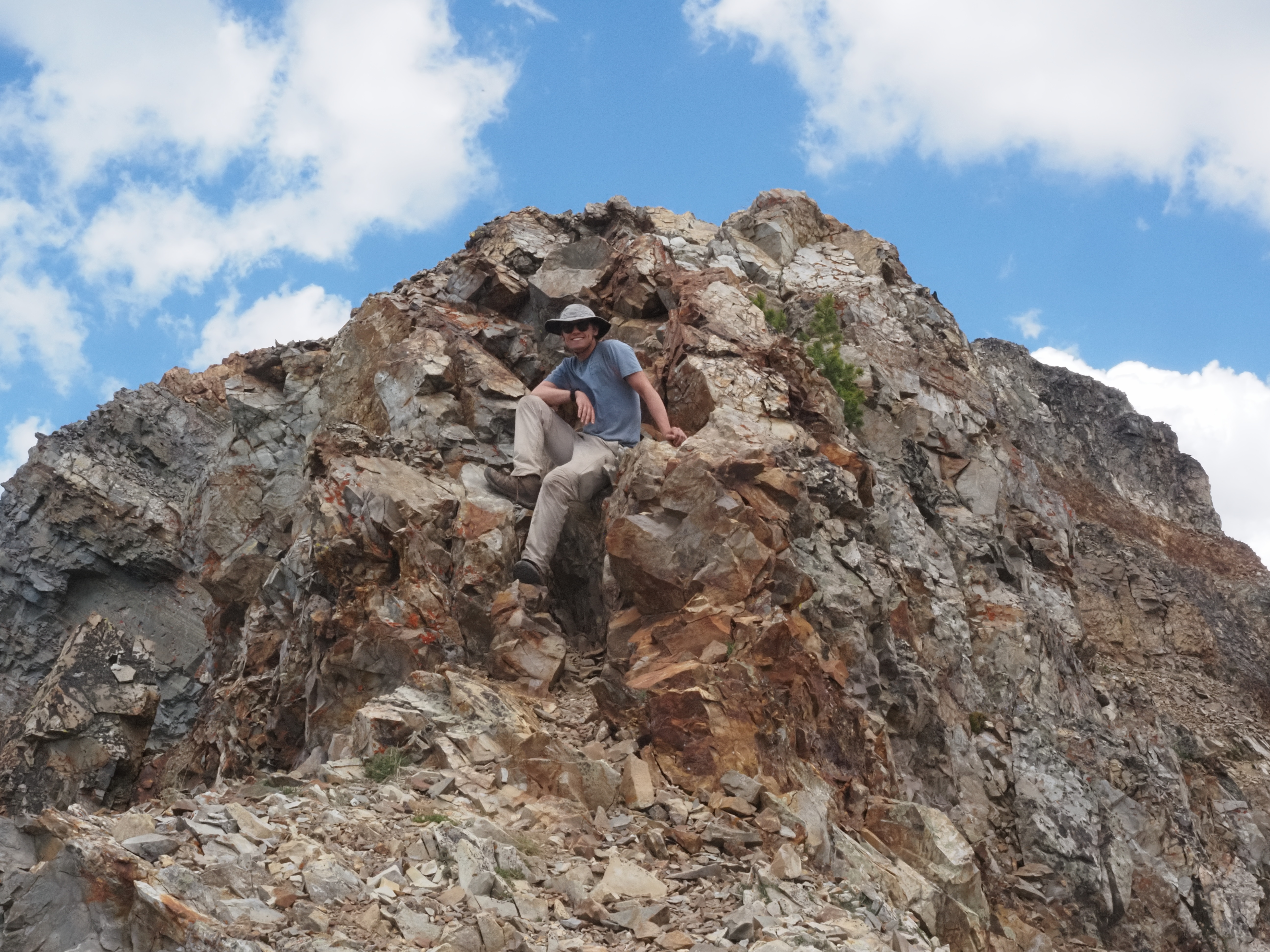 A photo of a person at a mountain summit